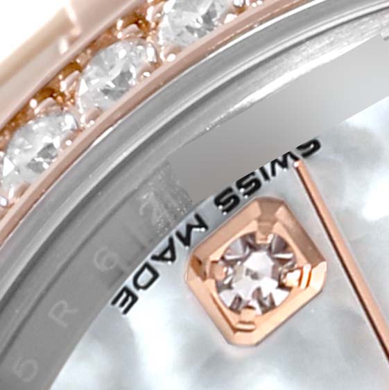 Close-up angle of a Rolex Datejust 279381RBR Women's Steel and Gold (two tone) Mother of Pearl Dial 279381RBR Women's Steel and Gold (two tone) Mother of Pearl Dial watch showing part of the bezel, diamond hour marker, and text "SWISS MADE."