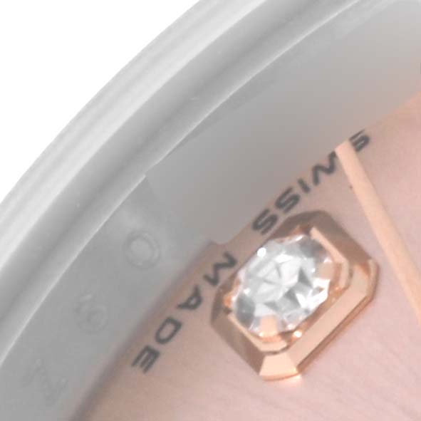 The close-up image of the Rolex Datejust 179171 Women's Steel and Gold (two tone) Pink Dial 179171 Women's Steel and Gold (two tone) Pink Dial watch showcases the dial with a gem-set hour marker and part of the text "SWISS MADE."