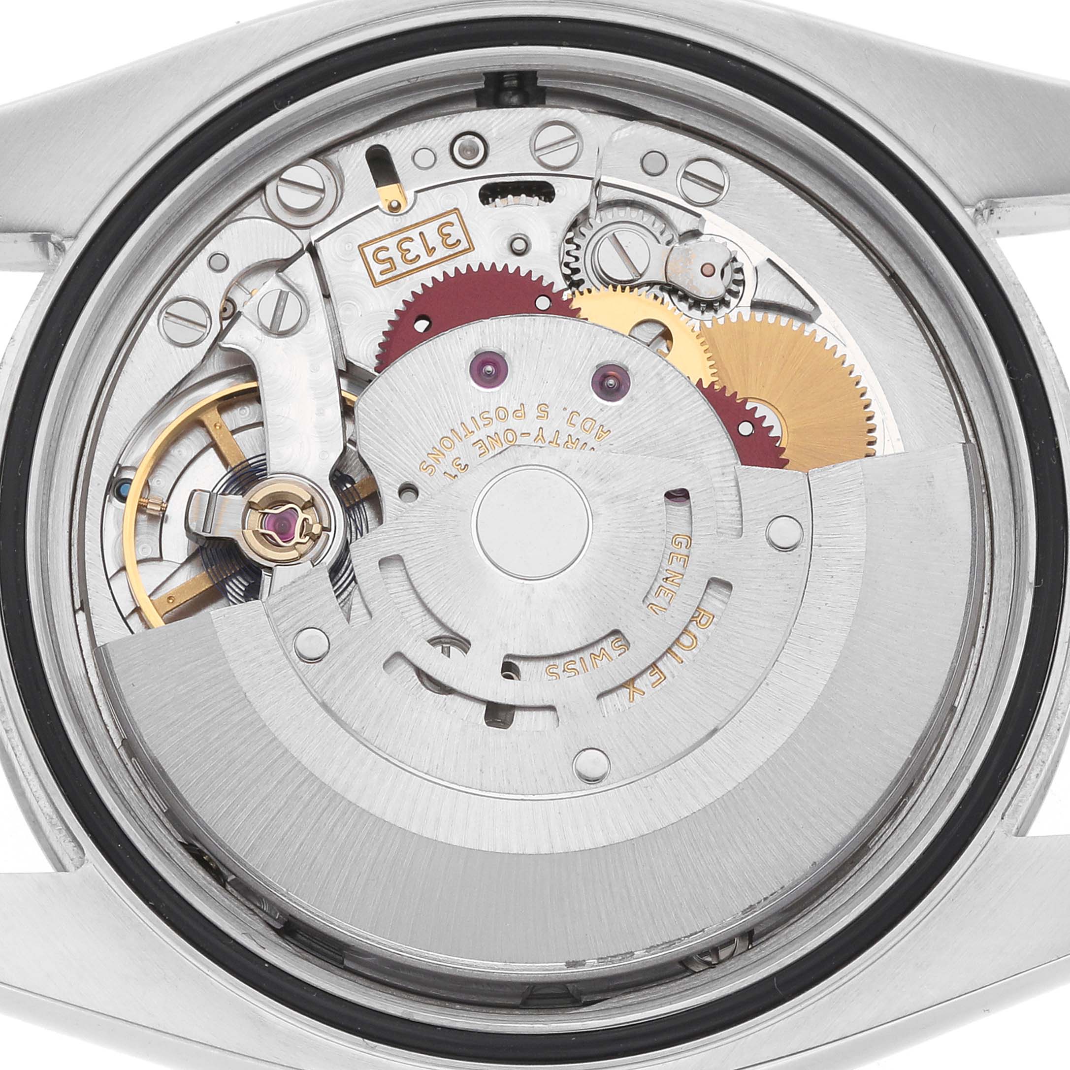 The image shows the movement of a Rolex Datejust 116234 Men
s Stainless Steel Silver Dial watch from the back, highlighting gears and mechanisms.