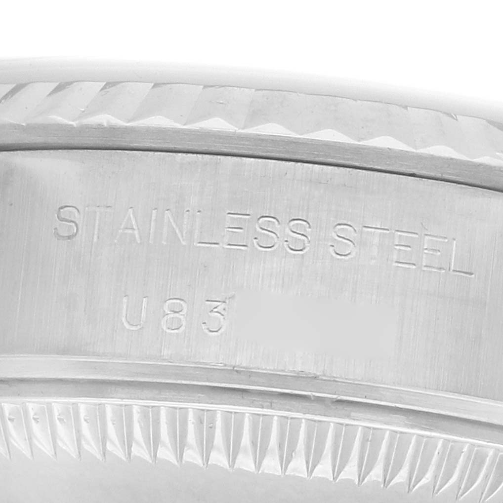 The image shows a close-up of the side of a Rolex Datejust 69174 Women's Stainless Steel Silver Dial watch, highlighting its stainless steel composition and fluted bezel.
