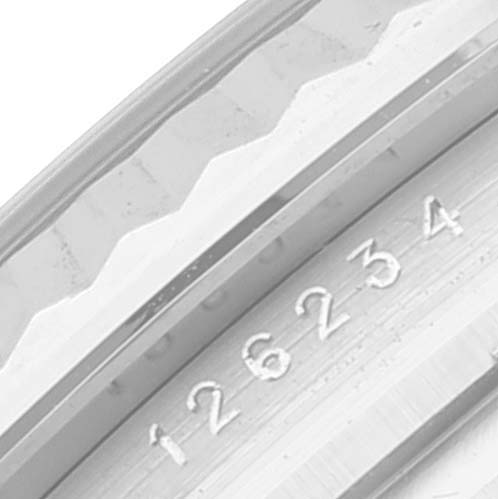 This close-up image shows the serial number engraving on the bezel of a Rolex Datejust 126234 Men's Stainless Steel Pink Dial 126234 Men's Stainless Steel Pink Dial watch.