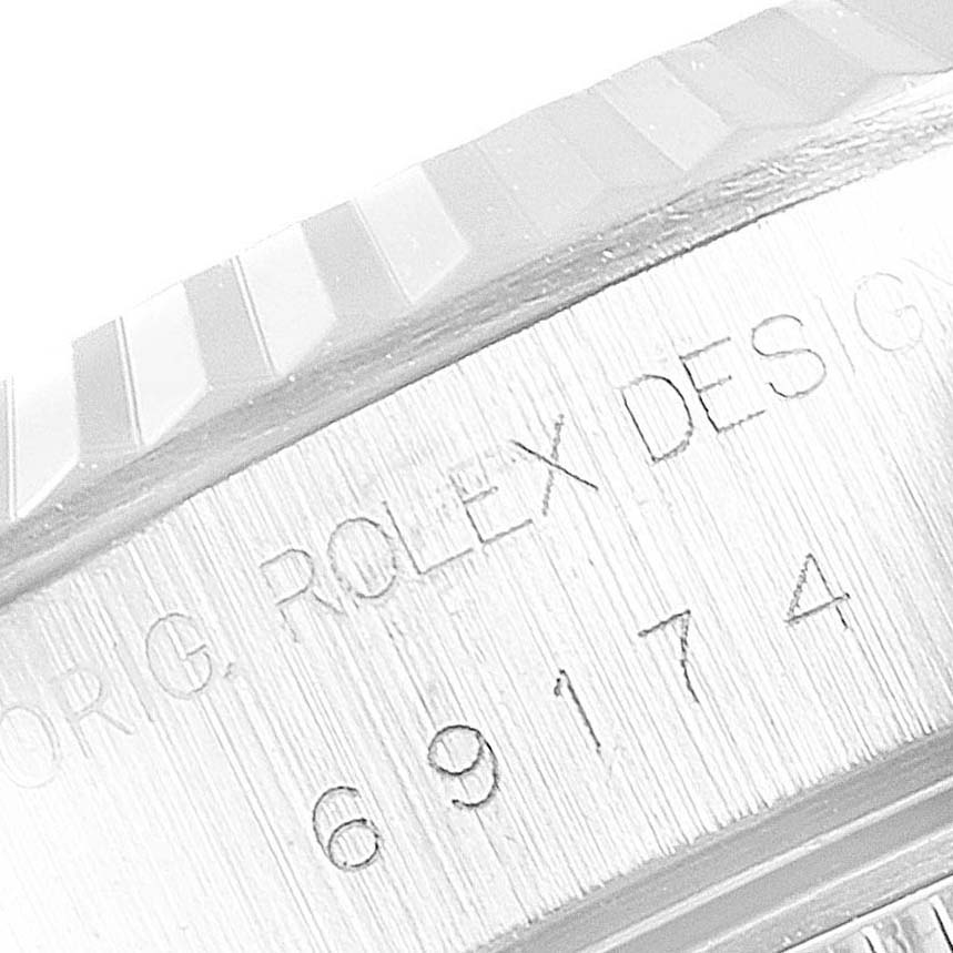 The image shows a close-up of the side engraving on the bezel and case of a Rolex Datejust 69174 Women's Stainless Steel Blue Dial 69174 Women's Stainless Steel Blue Dial watch, displaying the model number.