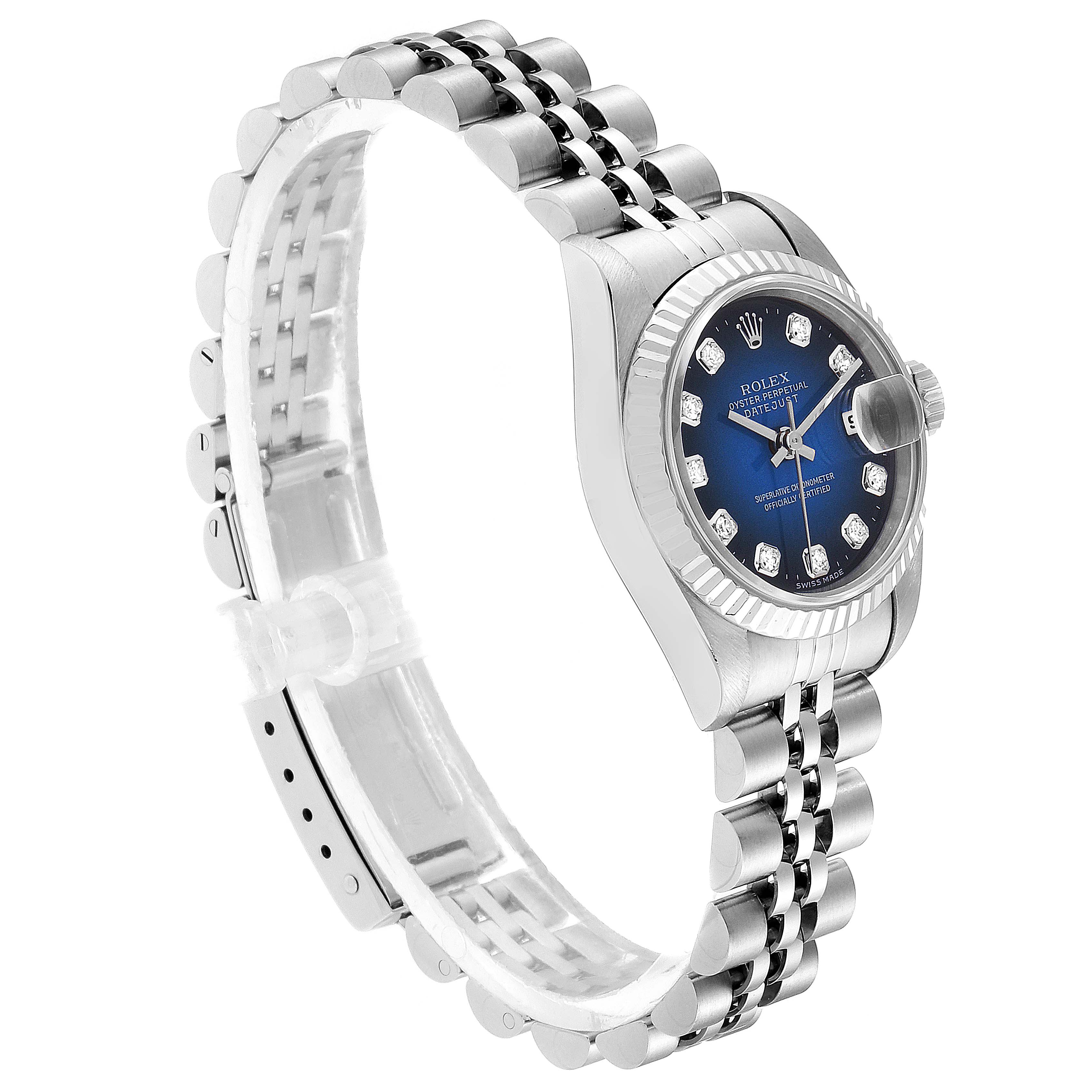 The image shows a side view of a Rolex Datejust 69174 Women's Stainless Steel Blue Dial 69174 Women's Stainless Steel Blue Dial watch, highlighting its blue dial, jubilee bracelet, and fluted bezel.