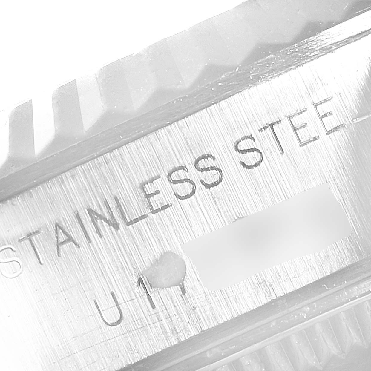 The image shows a close-up view of the case with the "STAINLESS STEEL" engraving on a Rolex Datejust 69174 Women's Stainless Steel Blue Dial 69174 Women's Stainless Steel Blue Dial watch.