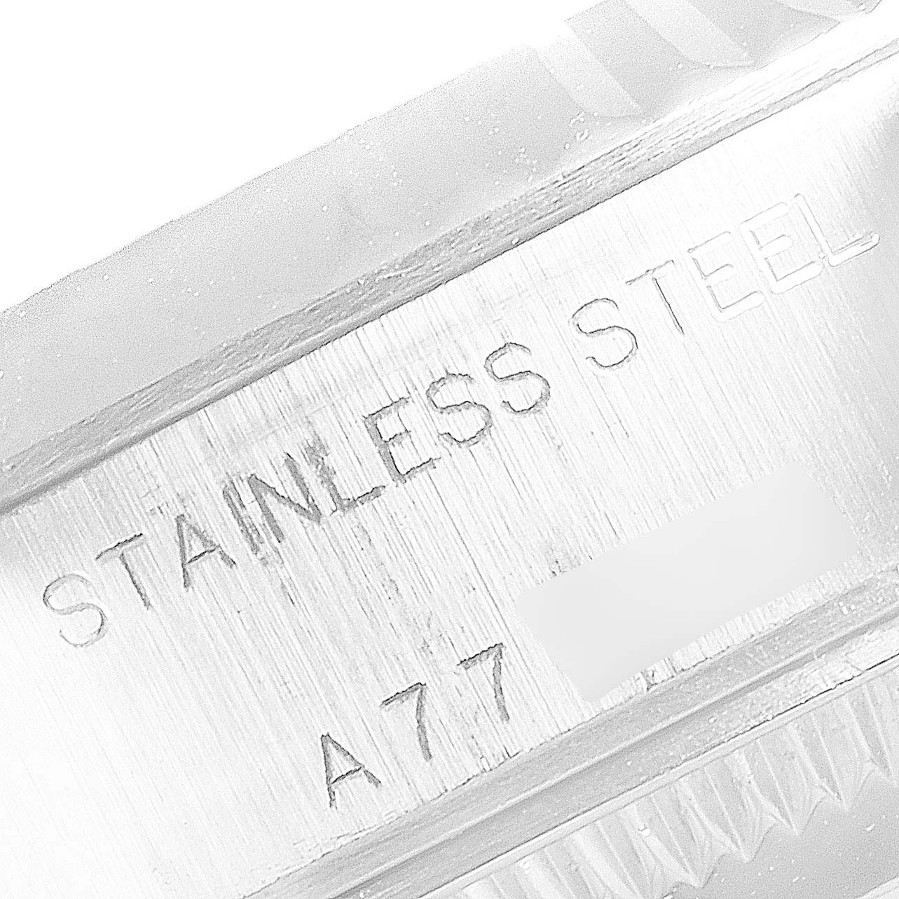 The image shows an engraved side of the case for a Rolex Datejust 79174 Women's Stainless Steel Blue Dial 79174 Women's Stainless Steel Blue Dial watch, indicating "STAINLESS STEEL."