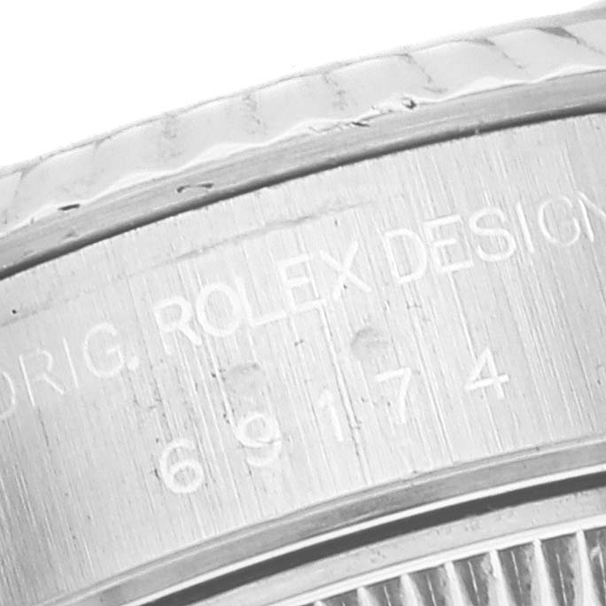 The image shows an angled close-up of the engraved case back for the Rolex Datejust 69174 Women's Stainless Steel Silver Dial 69174 Women's Stainless Steel Silver Dial model.