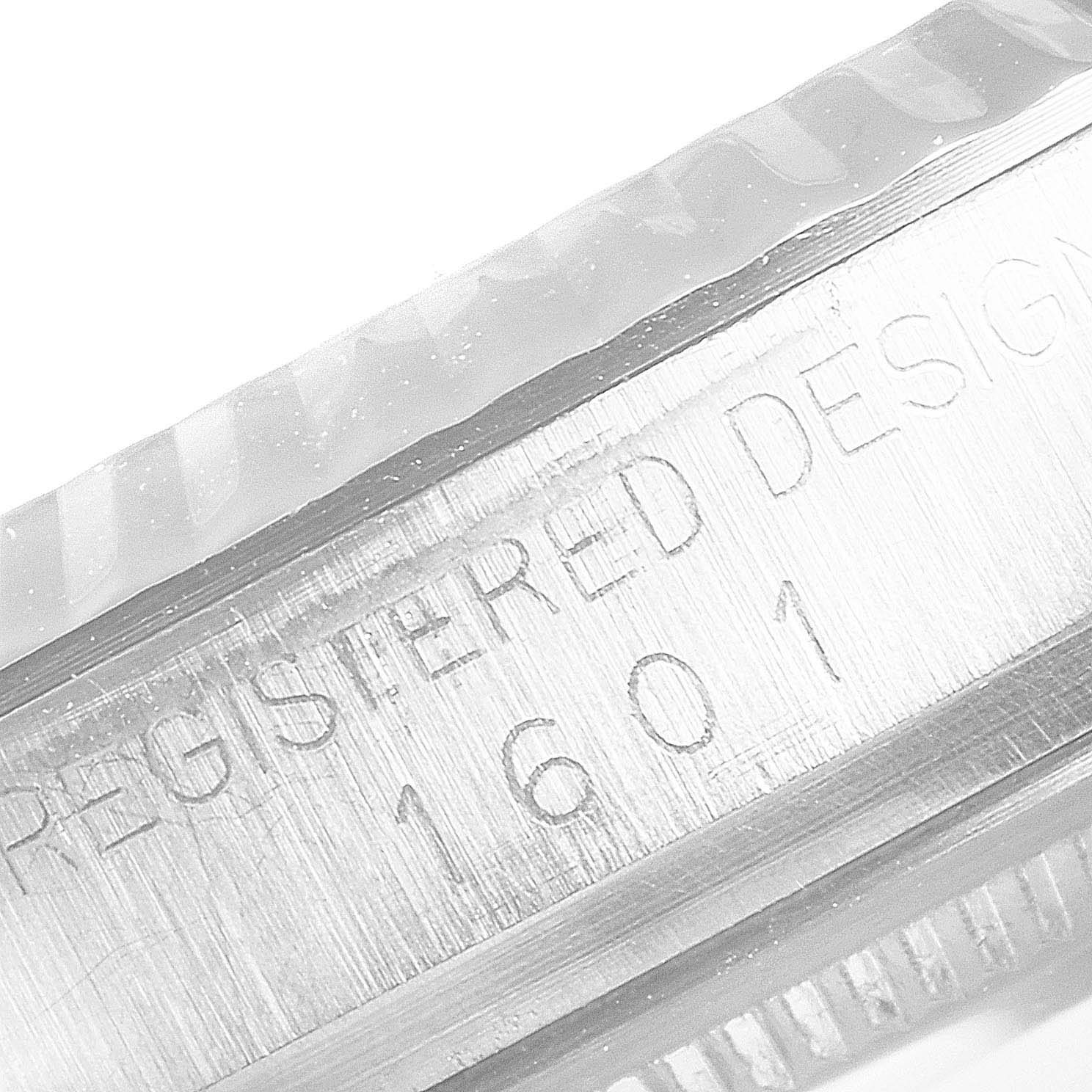 This is a close-up of the serial number and fluted bezel of a Rolex Vintage Collection 1601 Men
s Stainless Steel Silver Dial 1601 Men
s Stainless Steel Silver Dial model 1601.