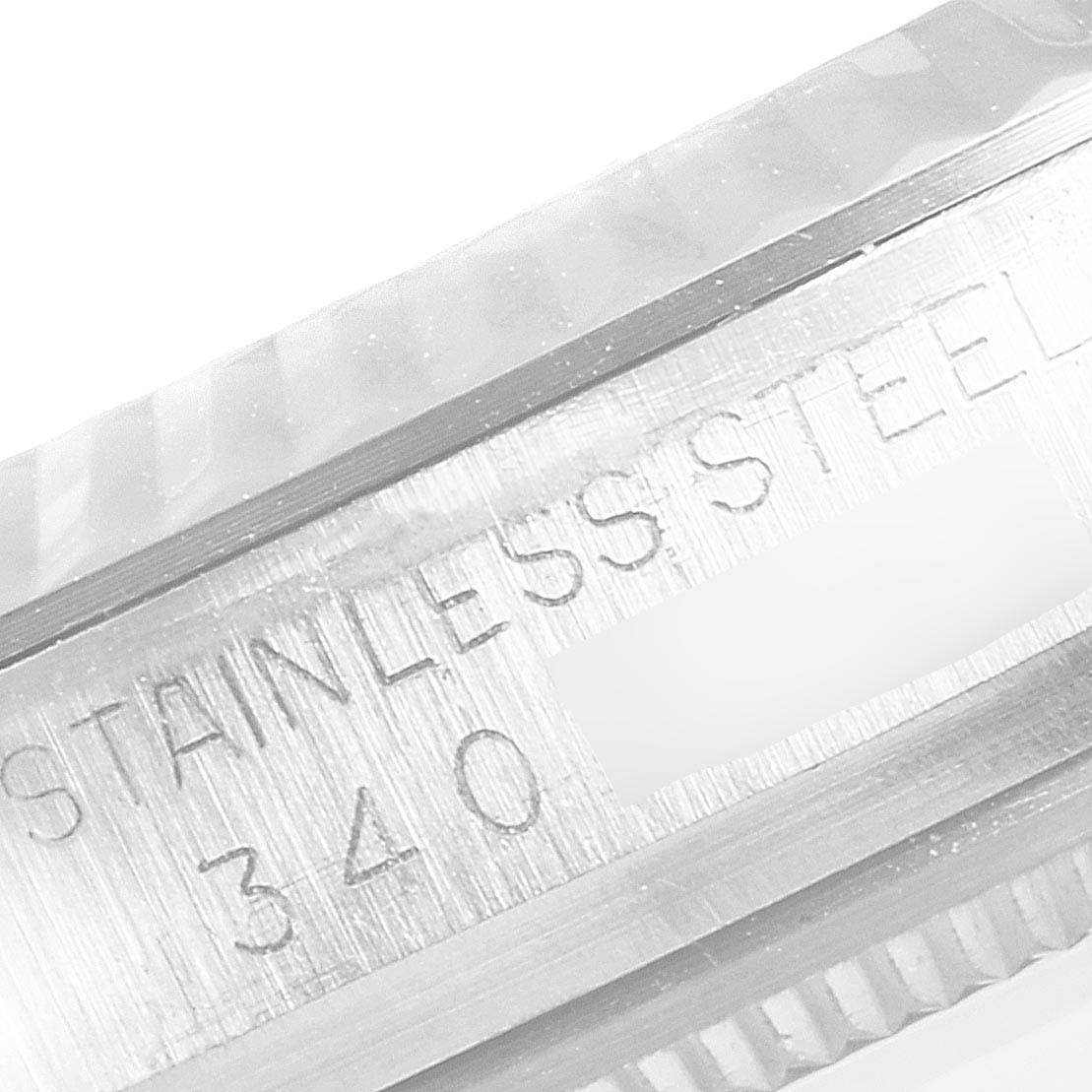 This image shows a close-up of a stainless steel marking and part of the bezel on a Vintage Collection model by Rolex.