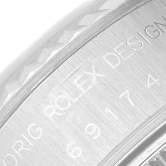 This image shows a close-up view of the engraved side of a Rolex Datejust 69174 Women's Stainless Steel White Dial 69174 Women's Stainless Steel White Dial watch casing.