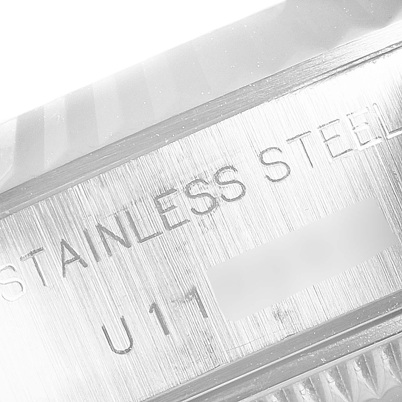 This close-up image shows the side of the case of a Rolex Datejust 69174 Women
s Stainless Steel White Dial 69174 Women
s Stainless Steel White Dial watch, highlighting its "STAINLESS STEEL" engraving.