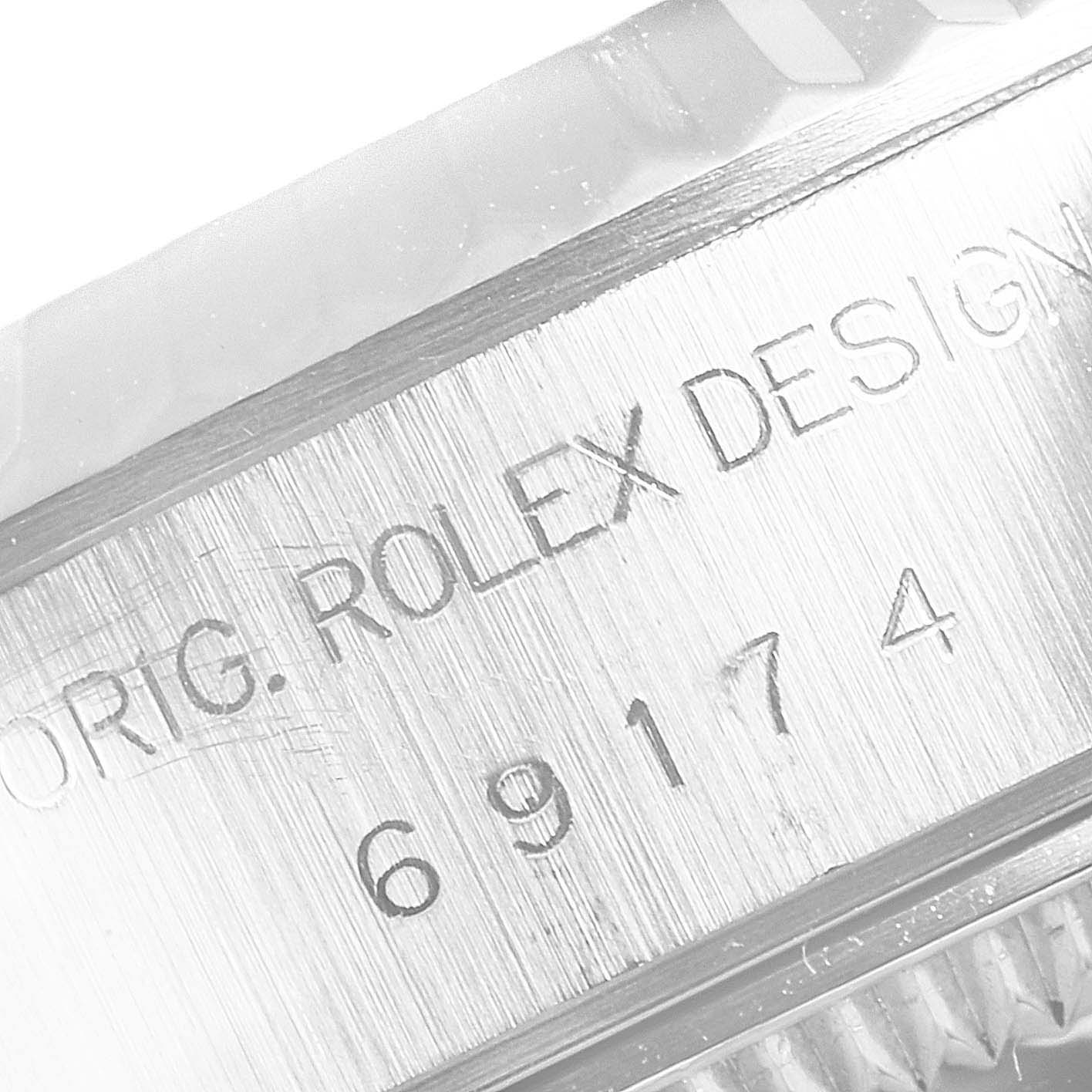 This close-up image shows the engravings on the side of the case of a Rolex Datejust 69174 Women
s Stainless Steel White Dial 69174 Women
s Stainless Steel White Dial watch.