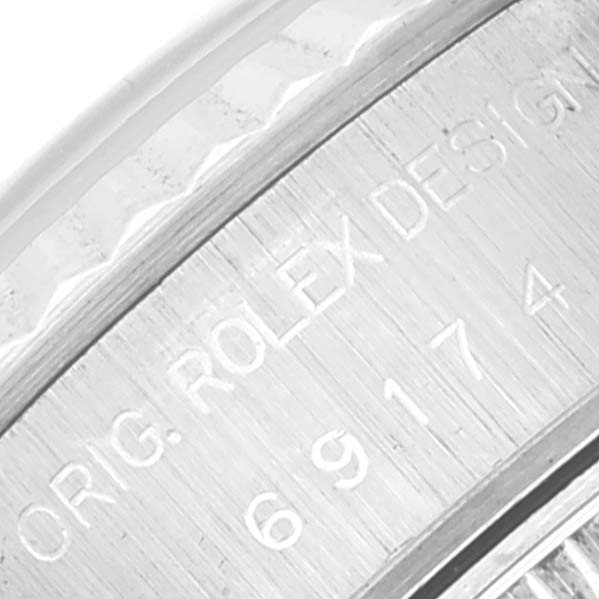 The image shows a close-up of the inner bezel and case engravings on a Rolex Datejust 69174 Women's Stainless Steel Silver Dial 69174 Women's Stainless Steel Silver Dial watch.