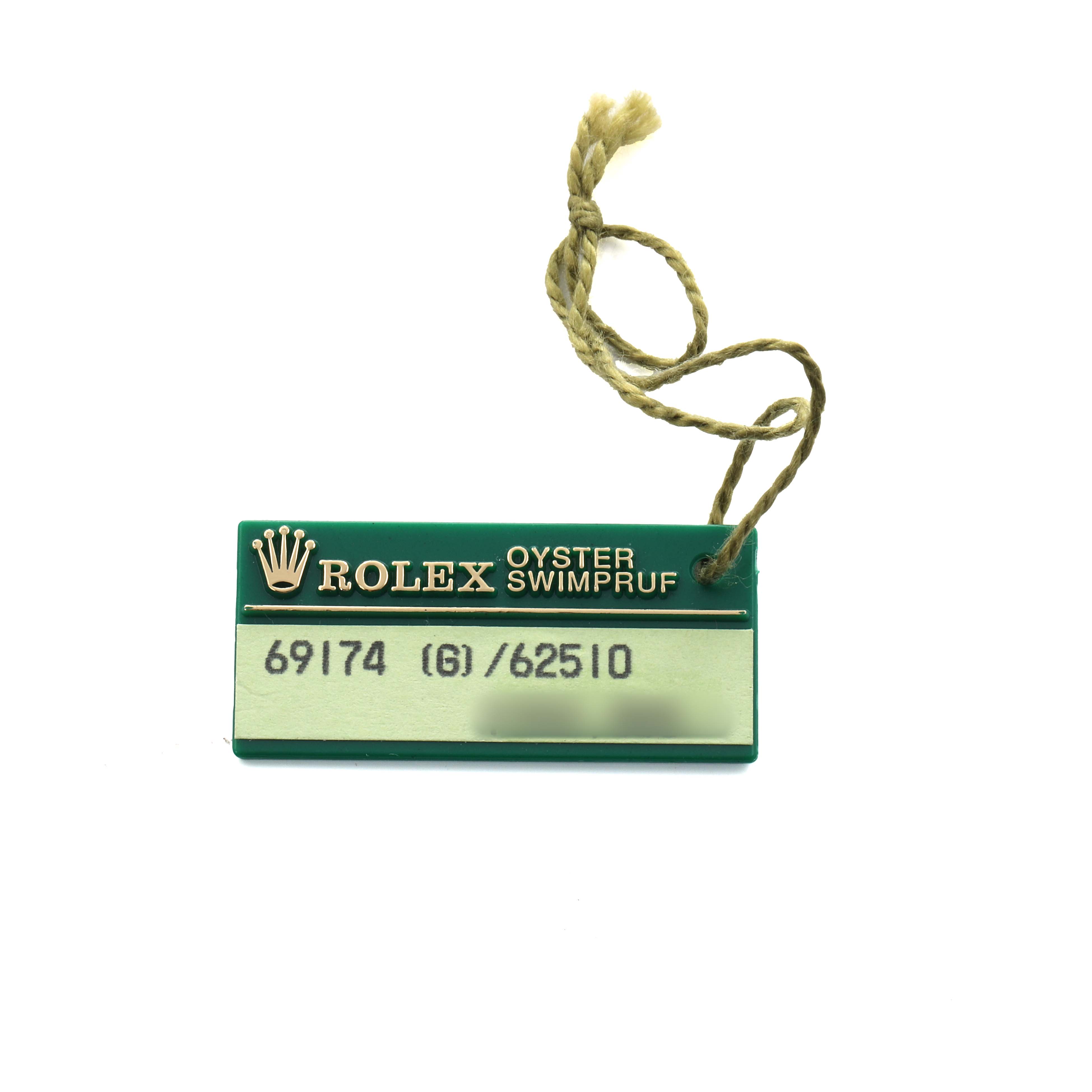 The image shows a green Rolex Oyster Swimpruf tag with model numbers for a Rolex Datejust 69174 Women's Stainless Steel Silver Dial watch.