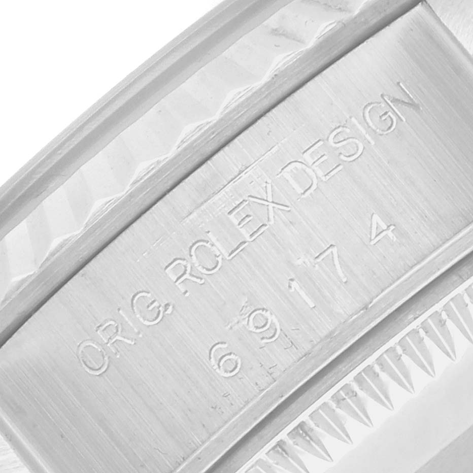 The image shows an engraved inner bezel of a Rolex Datejust 69174 Women's Stainless Steel Silver Dial watch with "ORIG. ROLEX DESIGN 69174" visible.