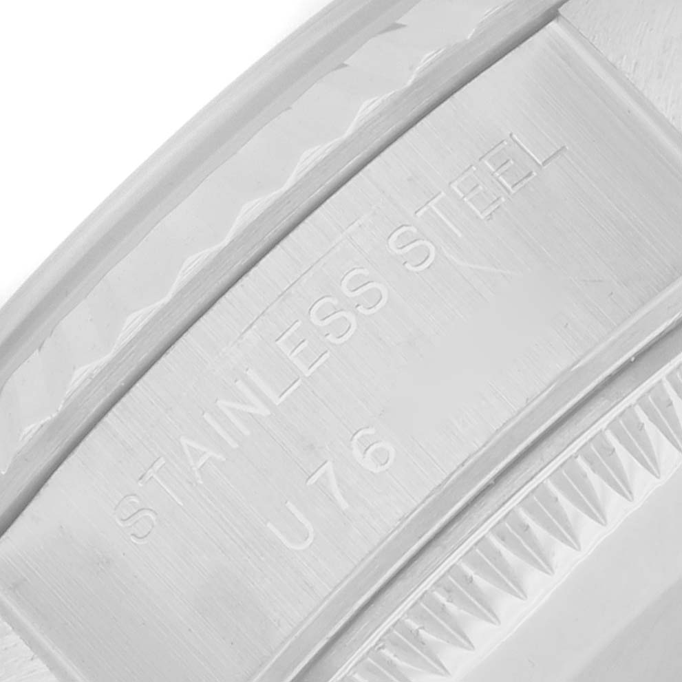 The image shows a close-up of the stainless steel edge with inscriptions on the Rolex Datejust 69174 Women's Stainless Steel Silver Dial model, focusing on the material details.