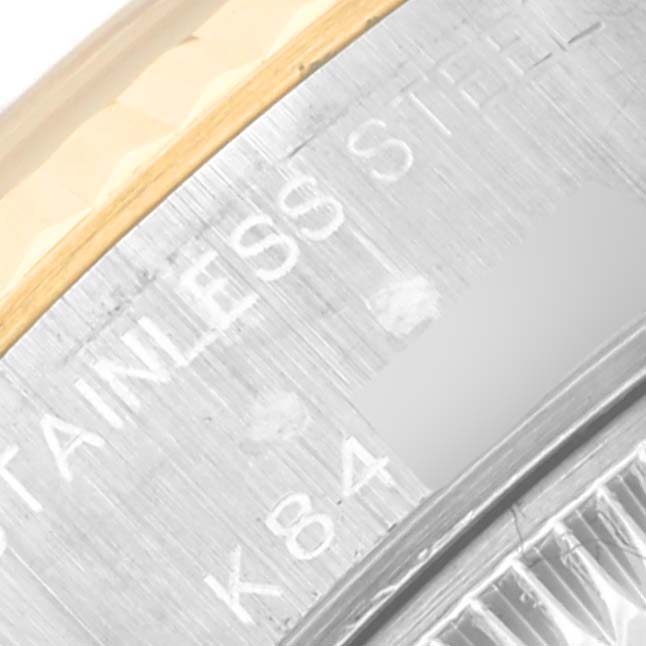 The image shows a close-up angle of the bezel and part of the case back of a Rolex Datejust 79173 Women's Steel and Gold (two tone) Blue Dial 79173 Women's Steel and Gold (two tone) Blue Dial model, highlighting stainless steel text.