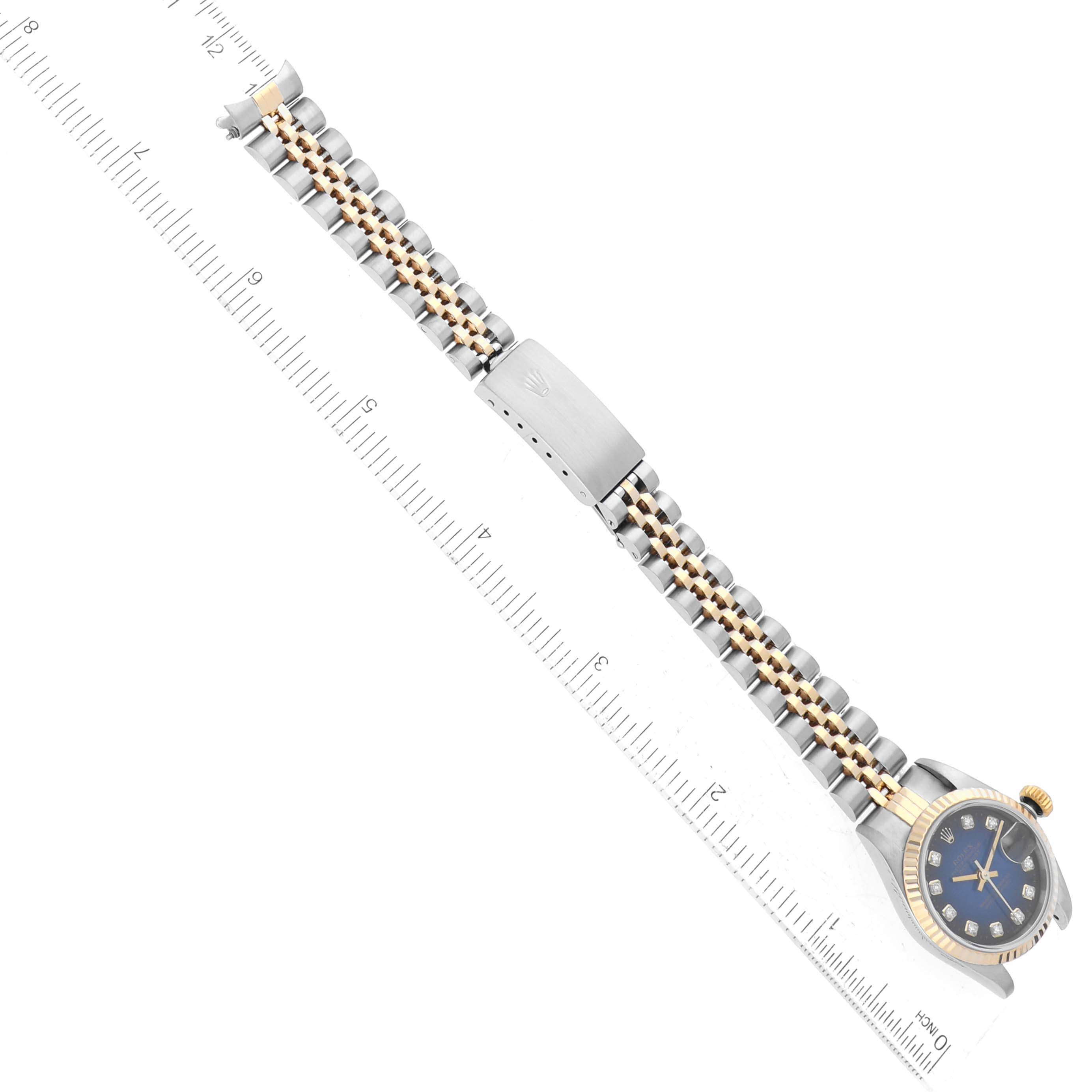 The image shows a side view of the Rolex Datejust 79173 Women's Steel and Gold (two tone) Blue Dial 79173 Women's Steel and Gold (two tone) Blue Dial watch with its face, bezel, crown, and bracelet fully extended.