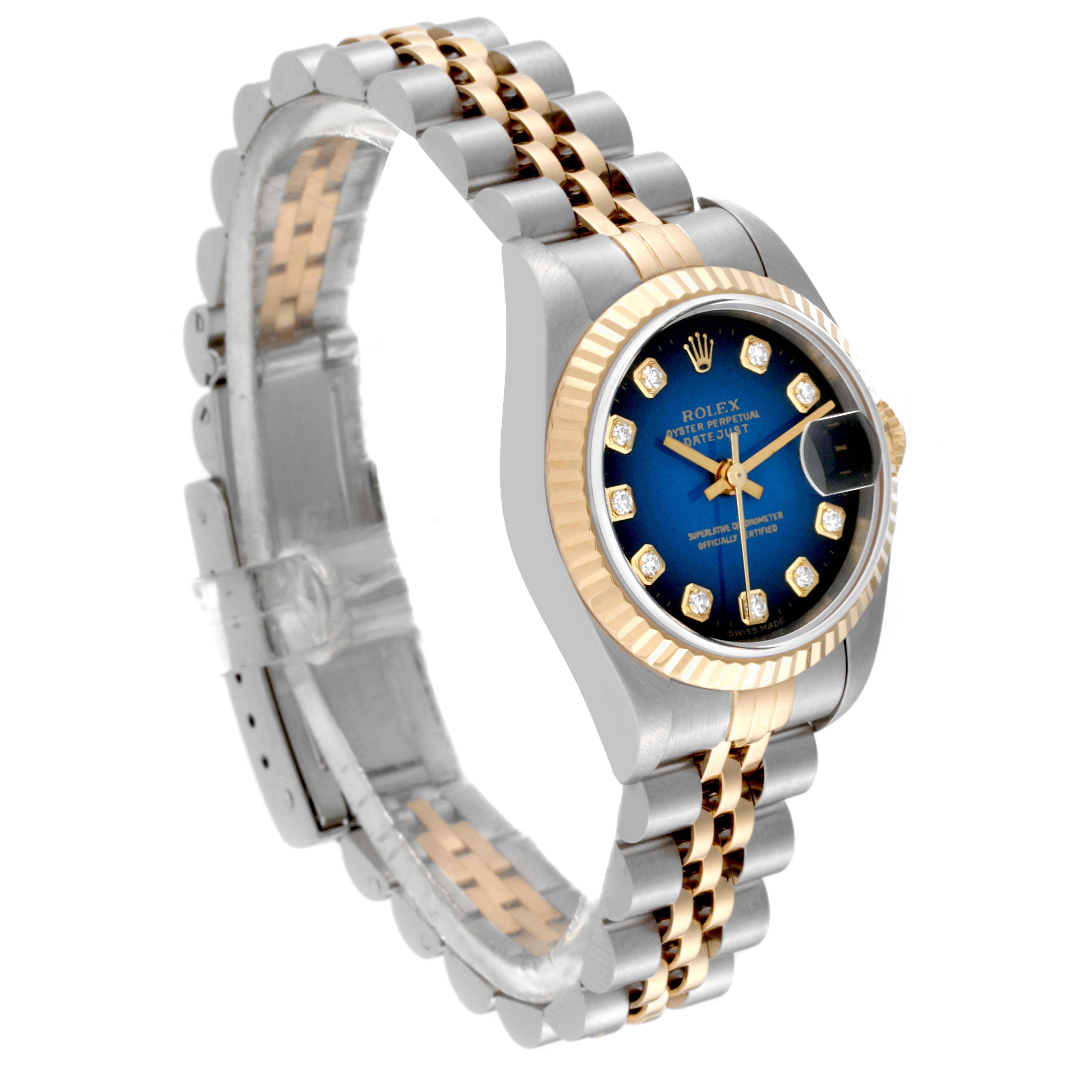 The image shows a Rolex Datejust 79173 Women's Steel and Gold (two tone) Blue Dial 79173 Women's Steel and Gold (two tone) Blue Dial watch from an angled view, highlighting its blue dial, gold and silver two-tone bracelet, and fluted bezel.