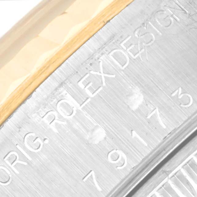 This image shows a close-up view of the side engravings on a Rolex Datejust 79173 Women's Steel and Gold (two tone) Blue Dial 79173 Women's Steel and Gold (two tone) Blue Dial watch.
