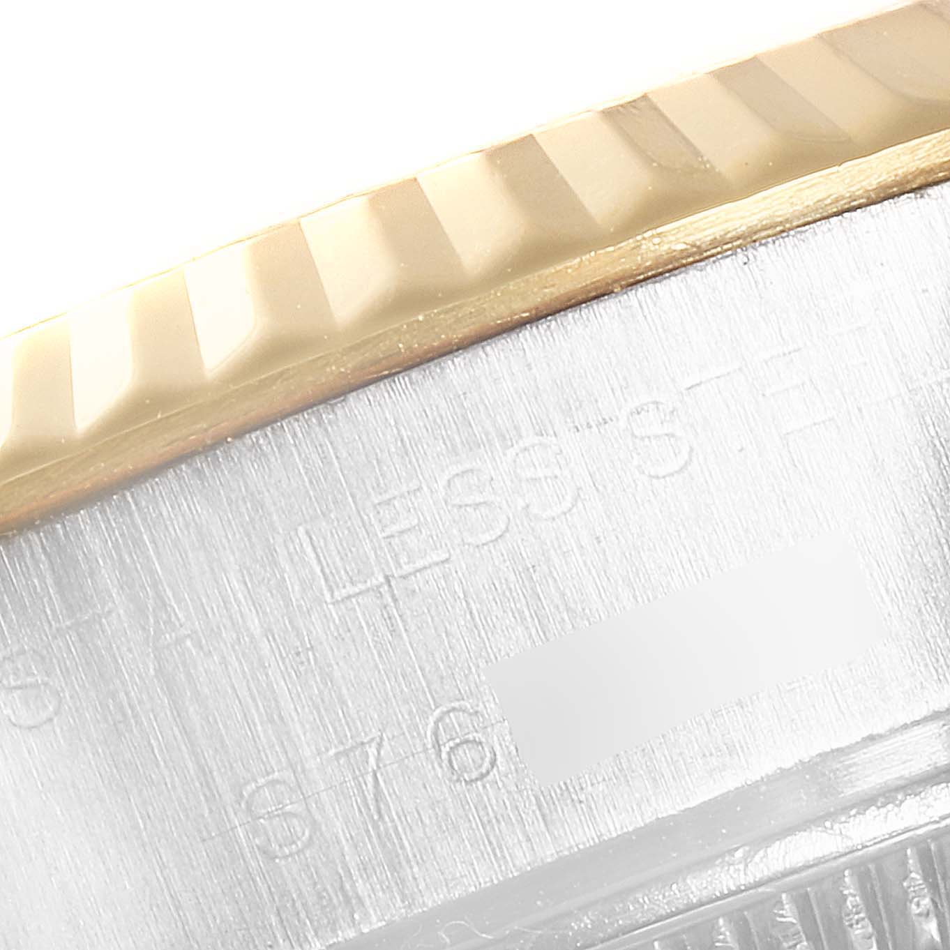 This close-up image shows the fluted bezel and part of the stainless steel case of a Rolex Datejust 69173 Women
s Steel and Gold (two tone) White Dial 69173 Women
s Steel and Gold (two tone) White Dial watch.