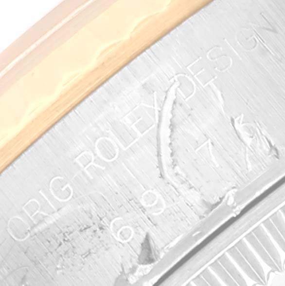 This image shows a close-up of the engraved case back of a Rolex Datejust 69173 Women's Steel and Gold (two tone) Champagne Dial 69173 Women's Steel and Gold (two tone) Champagne Dial watch.