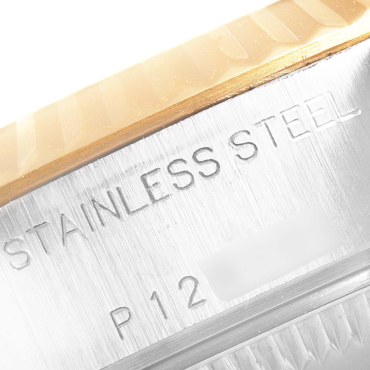 This image shows a close-up of the case side of a Rolex Datejust 79173 Women's Steel and Gold (two tone) Champagne Dial 79173 Women's Steel and Gold (two tone) Champagne Dial watch, highlighting the "Stainless Steel" engraving.