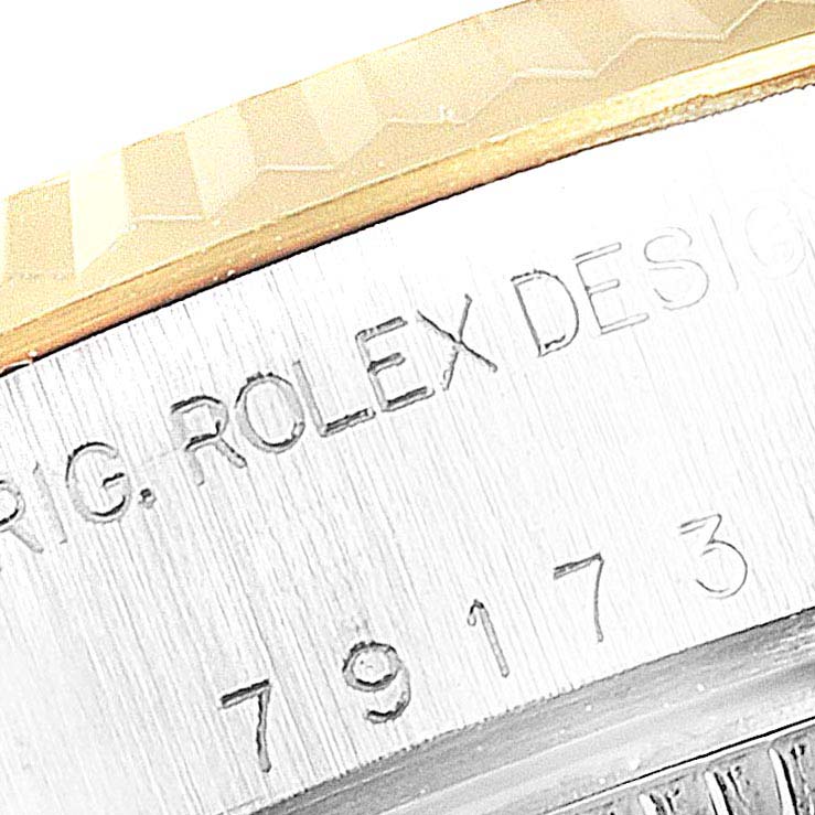 This close-up image shows the engraved serial number and bezel of a Rolex Datejust 79173 Women's Steel and Gold (two tone) Champagne Dial 79173 Women's Steel and Gold (two tone) Champagne Dial watch.