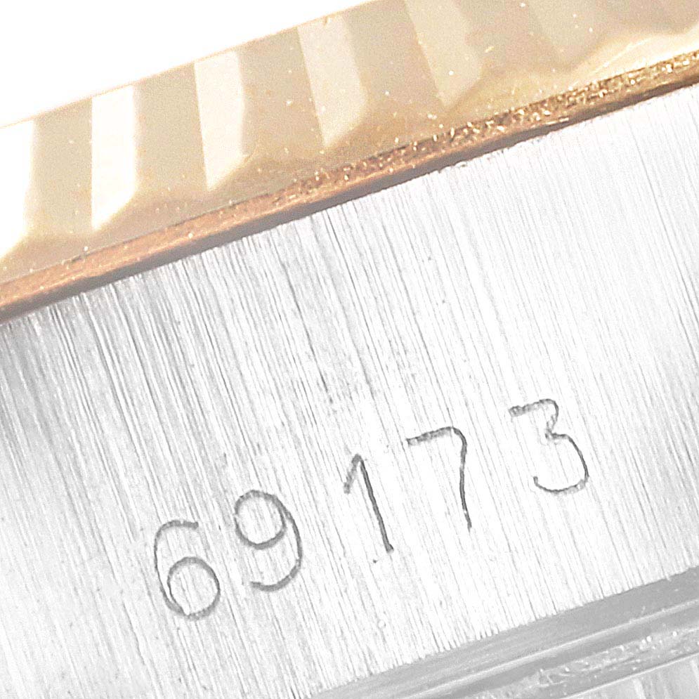 This image shows a close-up of the side of the case of the Rolex Datejust 69173 Women's Steel and Gold (two tone) Champagne Dial 69173 Women's Steel and Gold (two tone) Champagne Dial watch with a partial view of the bezel and the reference number 69173.