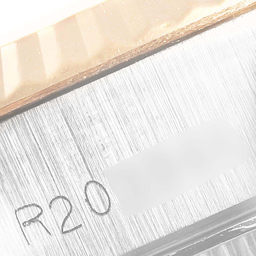 The image shows a close-up of the serial number and brushed metal surface on the side of a Rolex Datejust 69173 Women's Steel and Gold (two tone) Champagne Dial 69173 Women's Steel and Gold (two tone) Champagne Dial watch case.