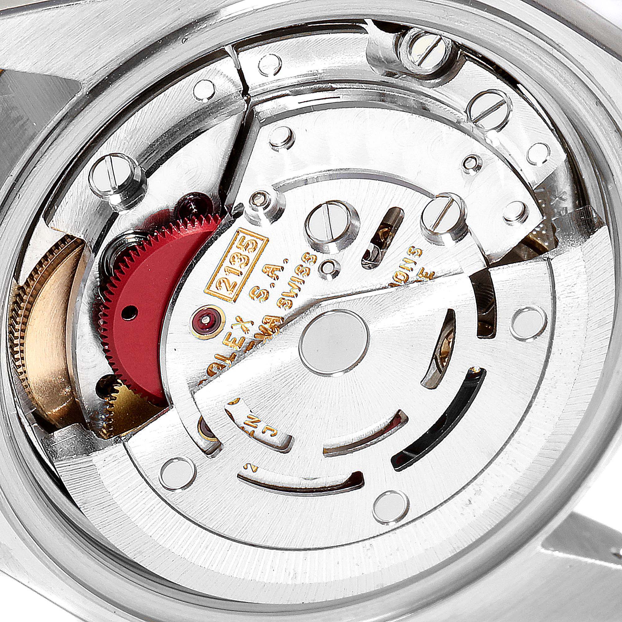 This image shows an angled close-up view of the Rolex Datejust 79173 Women
s Steel and Gold (two tone) Champagne Dial 79173 Women
s Steel and Gold (two tone) Champagne Dial watch
s movement and internal mechanics.