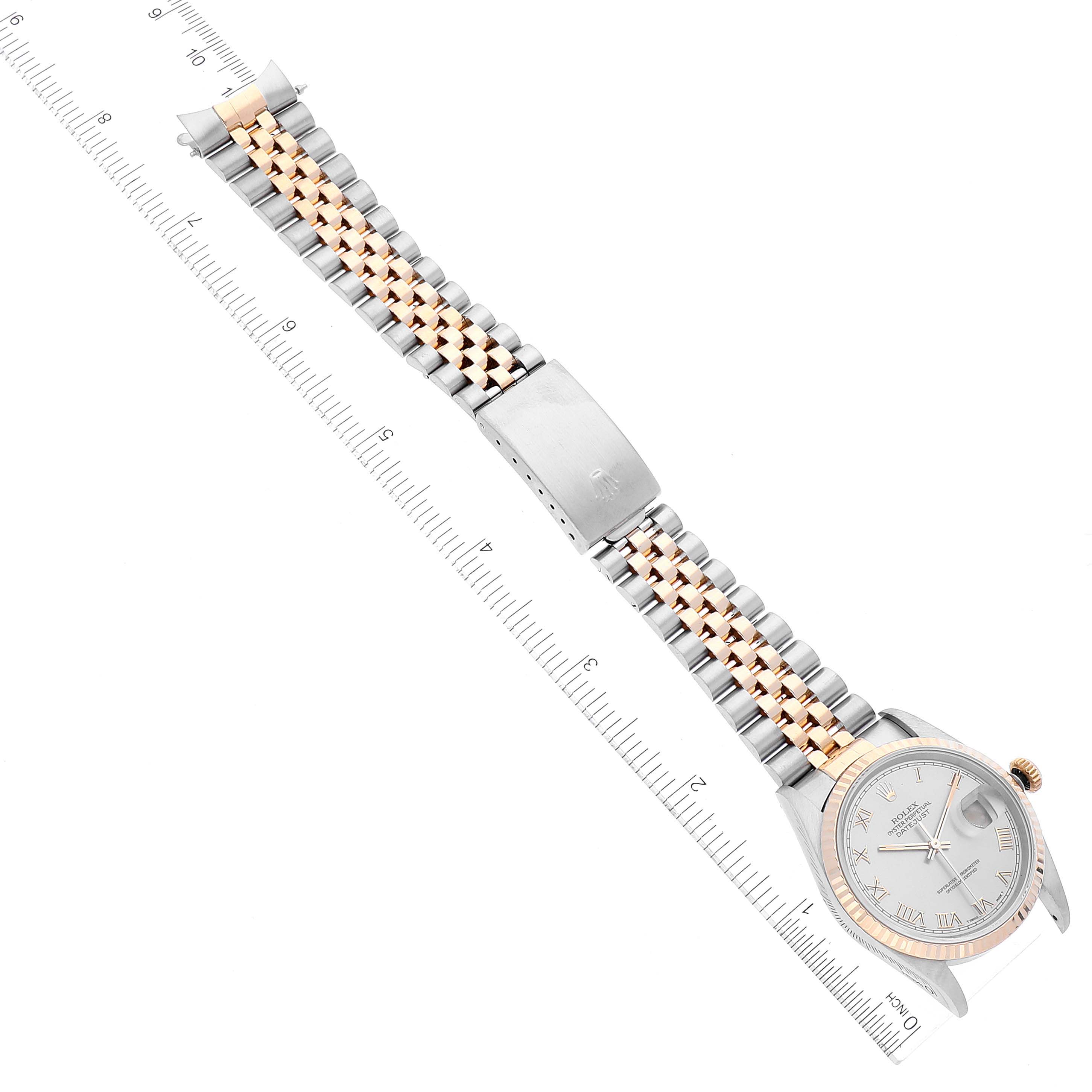 The image shows the Rolex Datejust 16233 Men
s Steel and Gold (two tone) Grey Dial 16233 Men
s Steel and Gold (two tone) Grey Dial watch laid flat from an overhead angle, displaying the entire watch and metal bracelet.