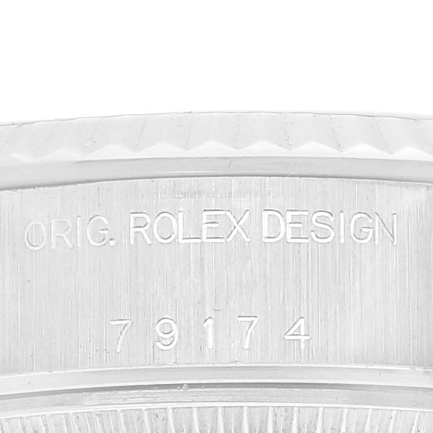 The image shows a close-up of the engraved model number and design inscription on the case of a Rolex Datejust 79174 Women's Stainless Steel Black Dial 79174 Women's Stainless Steel Black Dial watch.