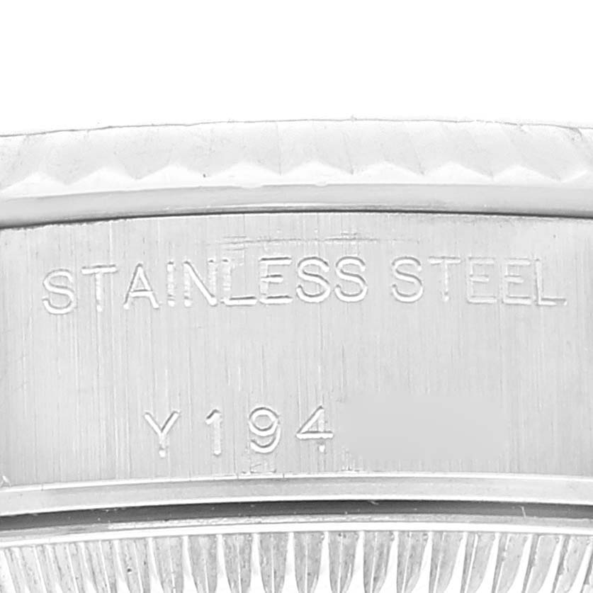 This image shows a close-up of the serial number engraving and stainless steel marking on the case back of a Rolex Datejust 79174 Women's Stainless Steel Black Dial 79174 Women's Stainless Steel Black Dial watch.
