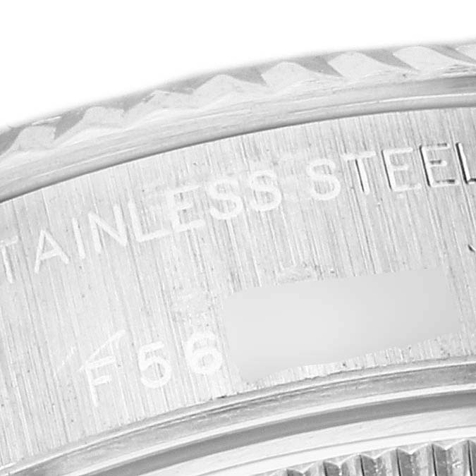 The image shows a close-up of the bezel and case side of a Rolex Datejust 79174 Women's Stainless Steel Mother of Pearl Dial 79174 Women's Stainless Steel Mother of Pearl Dial watch, highlighting the "STAINLESS STEEL" engraving.