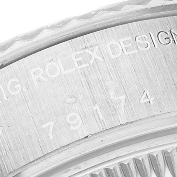 This image shows a close-up of the engraved bezel and case back of a Rolex Datejust 79174 Women's Stainless Steel Mother of Pearl Dial 79174 Women's Stainless Steel Mother of Pearl Dial watch.