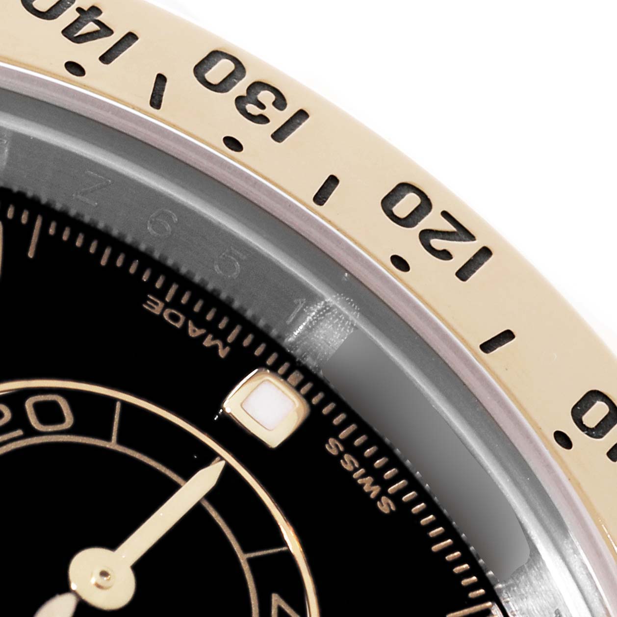 This image shows a close-up of the bezel and dial of a Rolex Daytona 116523 Men's Steel and Gold (two tone) Black Dial 116523 Men's Steel and Gold (two tone) Black Dial watch, highlighting the tachymeter scale and minute markers.