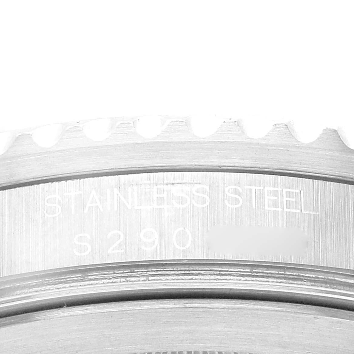 The image shows the edge of a Rolex GMT-Master 16710 Men
s Stainless Steel Black Dial 16710 Men
s Stainless Steel Black Dial watch case, detailing the stainless steel material and part of the serial number.