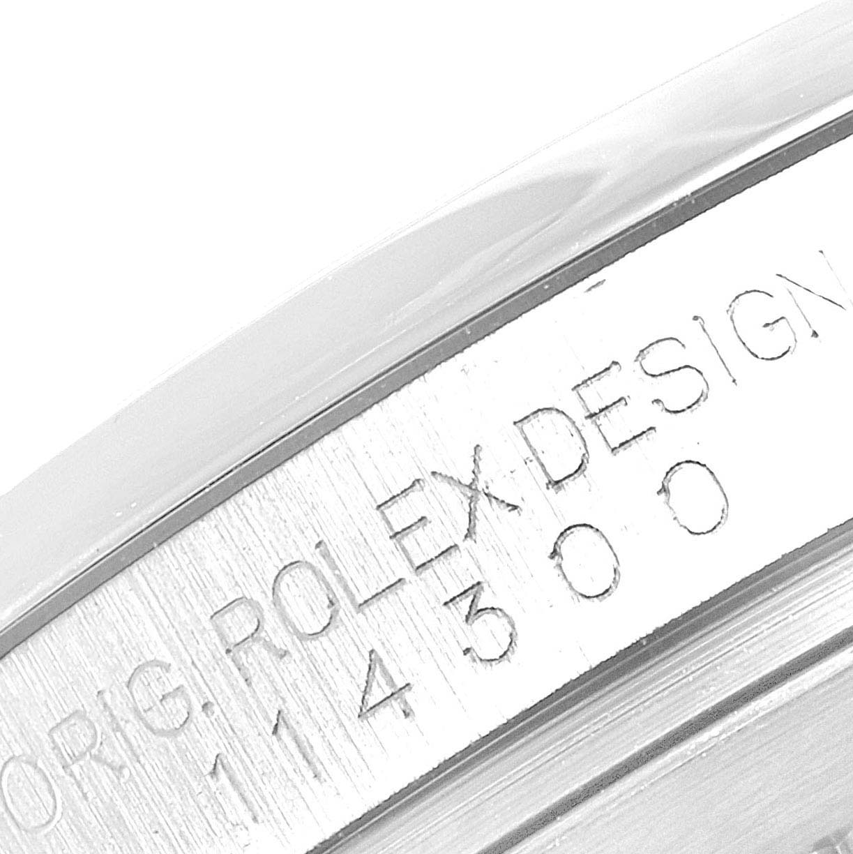 The image shows a close-up of the serial number engraving on the case of a Rolex Oyster Perpetual 114300 Men's Stainless Steel Blue Dial 114300 Men's Stainless Steel Blue Dial watch.