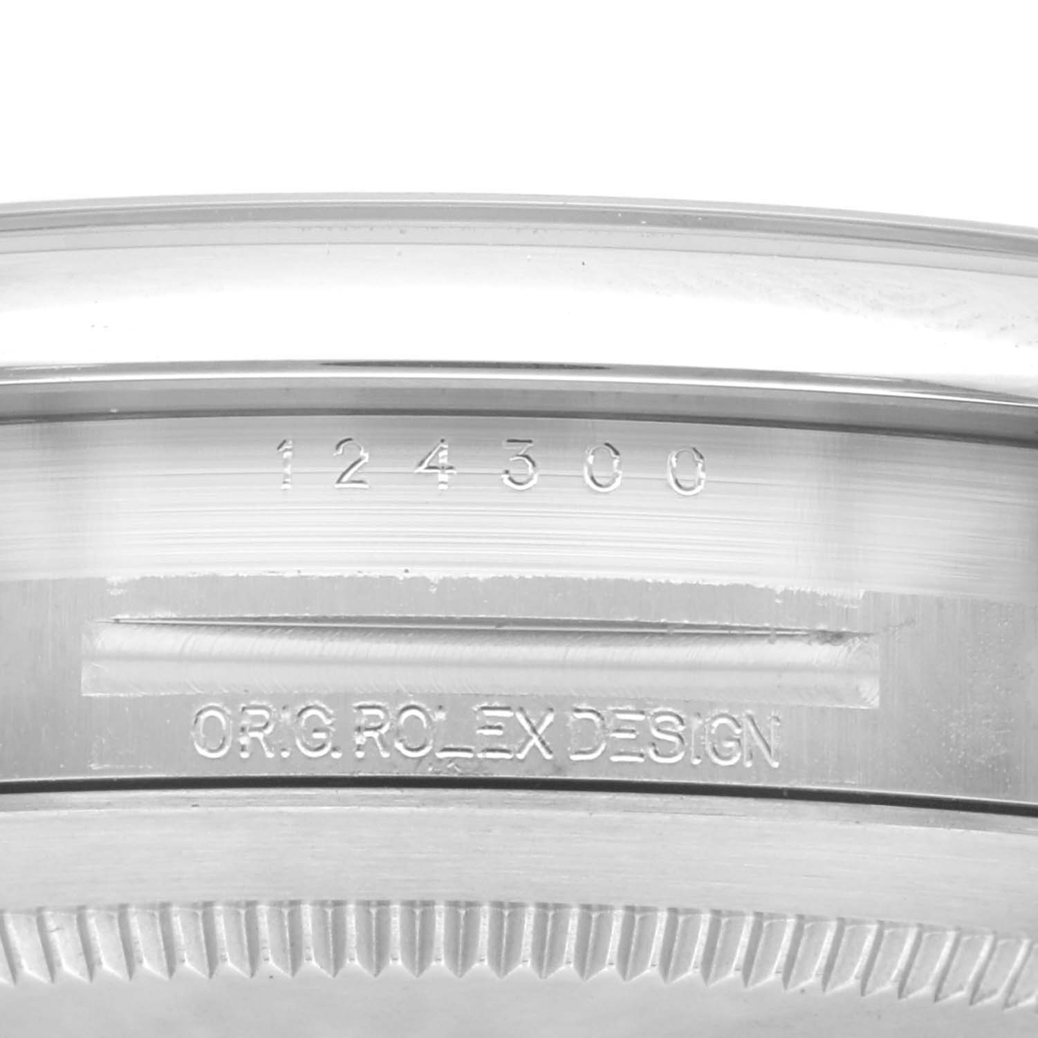 The image shows a close-up of the side of a Rolex Oyster Perpetual 124300 Men's Stainless Steel Silver Dial 124300 Men's Stainless Steel Silver Dial watch, highlighting the model number 124300 and design inscription.