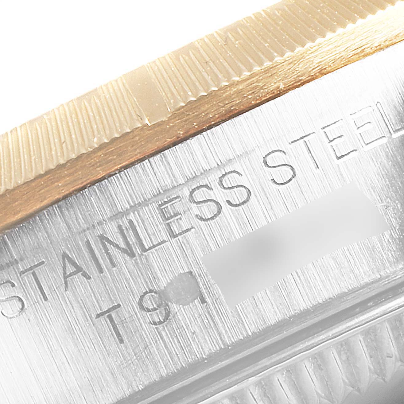 This close-up image of the Rolex Datejust 67243 Women's Steel and Gold (two tone) White Dial 67243 Women's Steel and Gold (two tone) White Dial model shows the watch's stainless steel side and its fluted bezel.