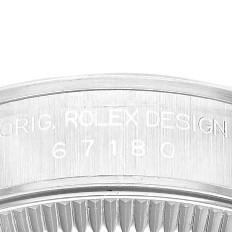 This image features a close-up of the case back of an Oyster Perpetual Rolex watch, displaying the engraving and ridges.