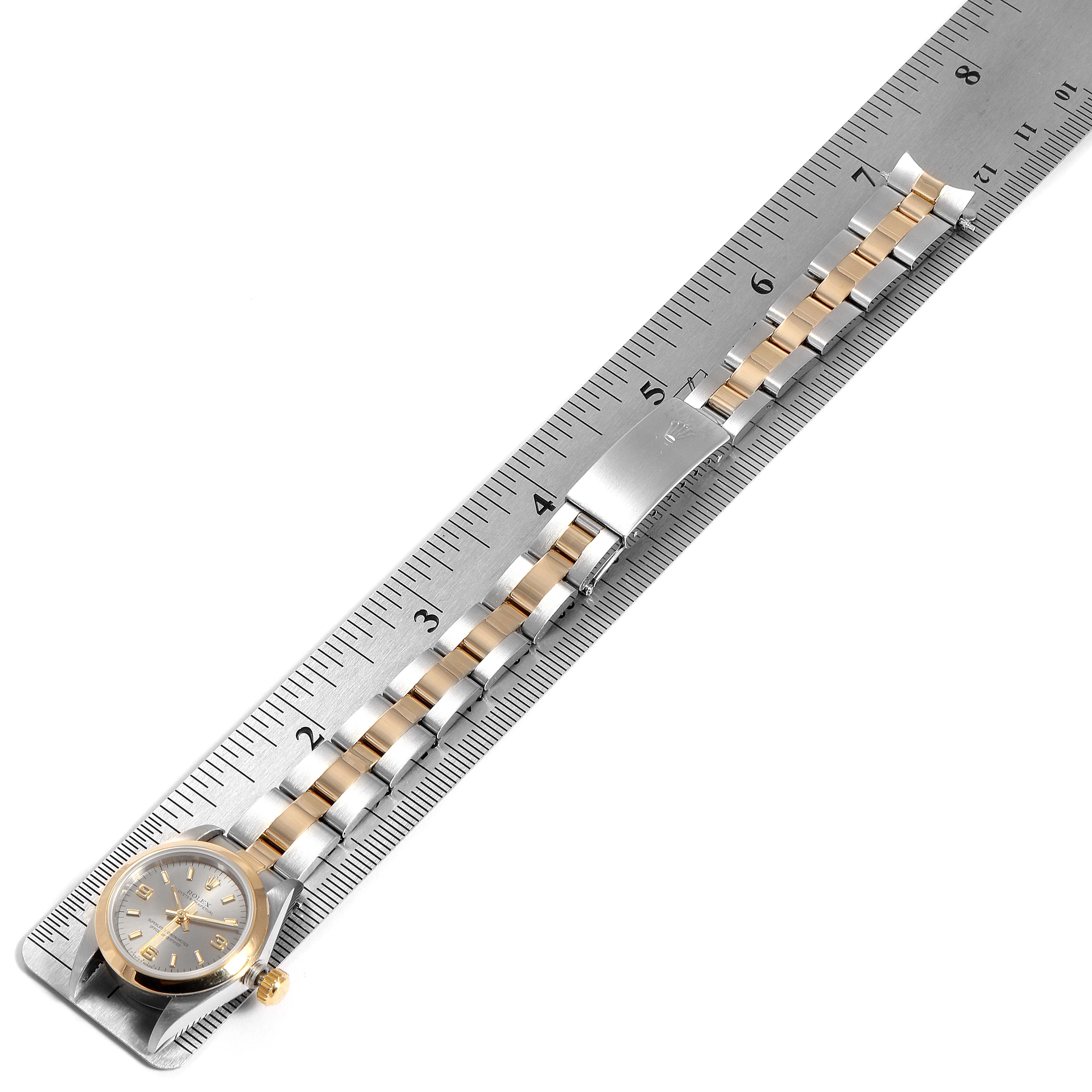The image shows a Rolex Datejust 67183 Women
s Steel and Gold (two tone) Grey Dial 67183 Women
s Steel and Gold (two tone) Grey Dial watch positioned flat with the entire band measured against a ruler.