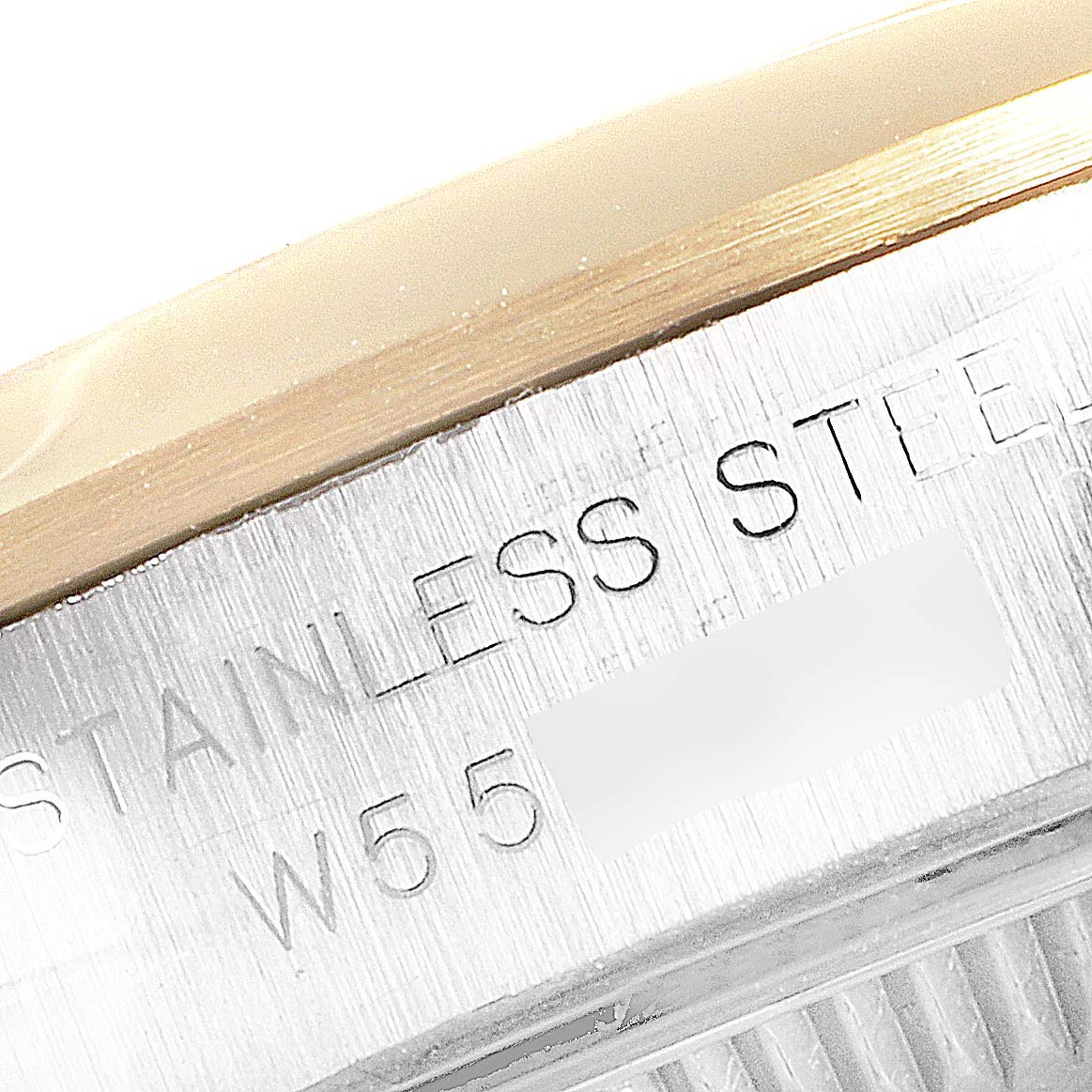 This close-up image shows the side engraving on the stainless steel case of a Rolex Datejust 67183 Women
s Steel and Gold (two tone) Grey Dial 67183 Women
s Steel and Gold (two tone) Grey Dial watch.