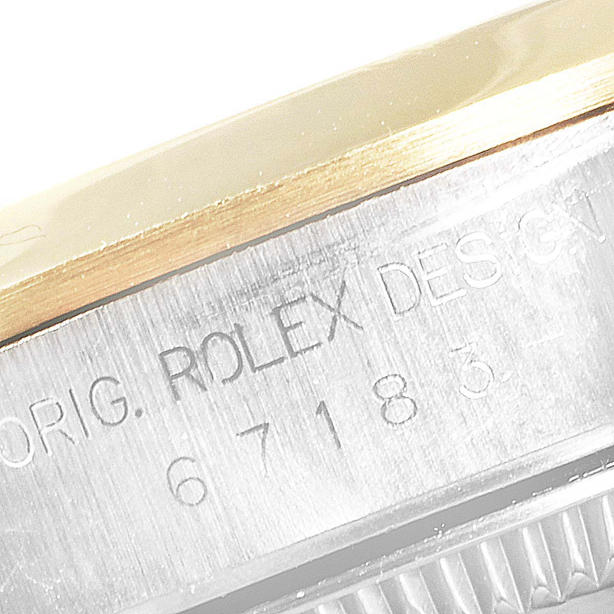 This close-up of a Rolex Datejust 67183 Women
s Steel and Gold (two tone) Grey Dial 67183 Women
s Steel and Gold (two tone) Grey Dial shows the engraving on the side of the watch case, including the serial number.