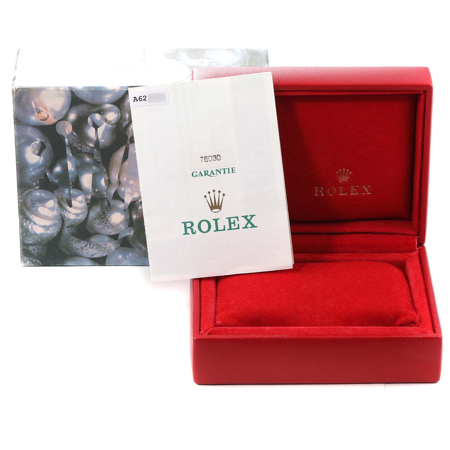 The image shows a Rolex Oyster Perpetual 76030 Women's Stainless Steel Pink Dial 76030 Women's Stainless Steel Pink Dial model's red watch box and warranty card from a front angle.