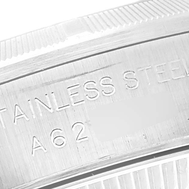 This image shows a close-up of the engraved "STAINLESS STEEL" text on the inner side of the bezel of a Rolex Oyster Perpetual 76030 Women's Stainless Steel Pink Dial 76030 Women's Stainless Steel Pink Dial watch.
