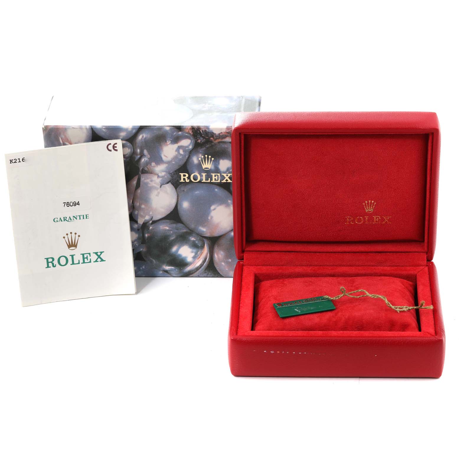 This image shows the packaging, a red Rolex box, and the guarantee booklet for the Rolex Oyster Perpetual 76094 Women's Stainless Steel Black Dial 76094 Women's Stainless Steel Black Dial model.