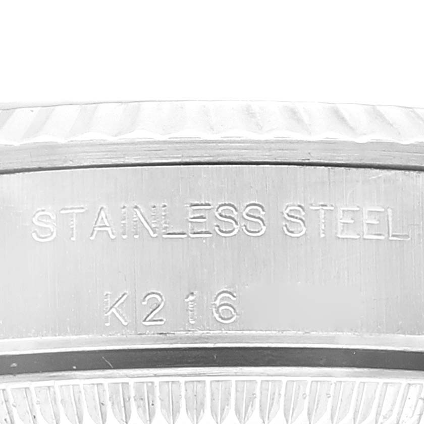 The image shows a close-up of the case back of a Rolex Oyster Perpetual 76094 Women's Stainless Steel Black Dial 76094 Women's Stainless Steel Black Dial watch, highlighting the "STAINLESS STEEL" engraving.
