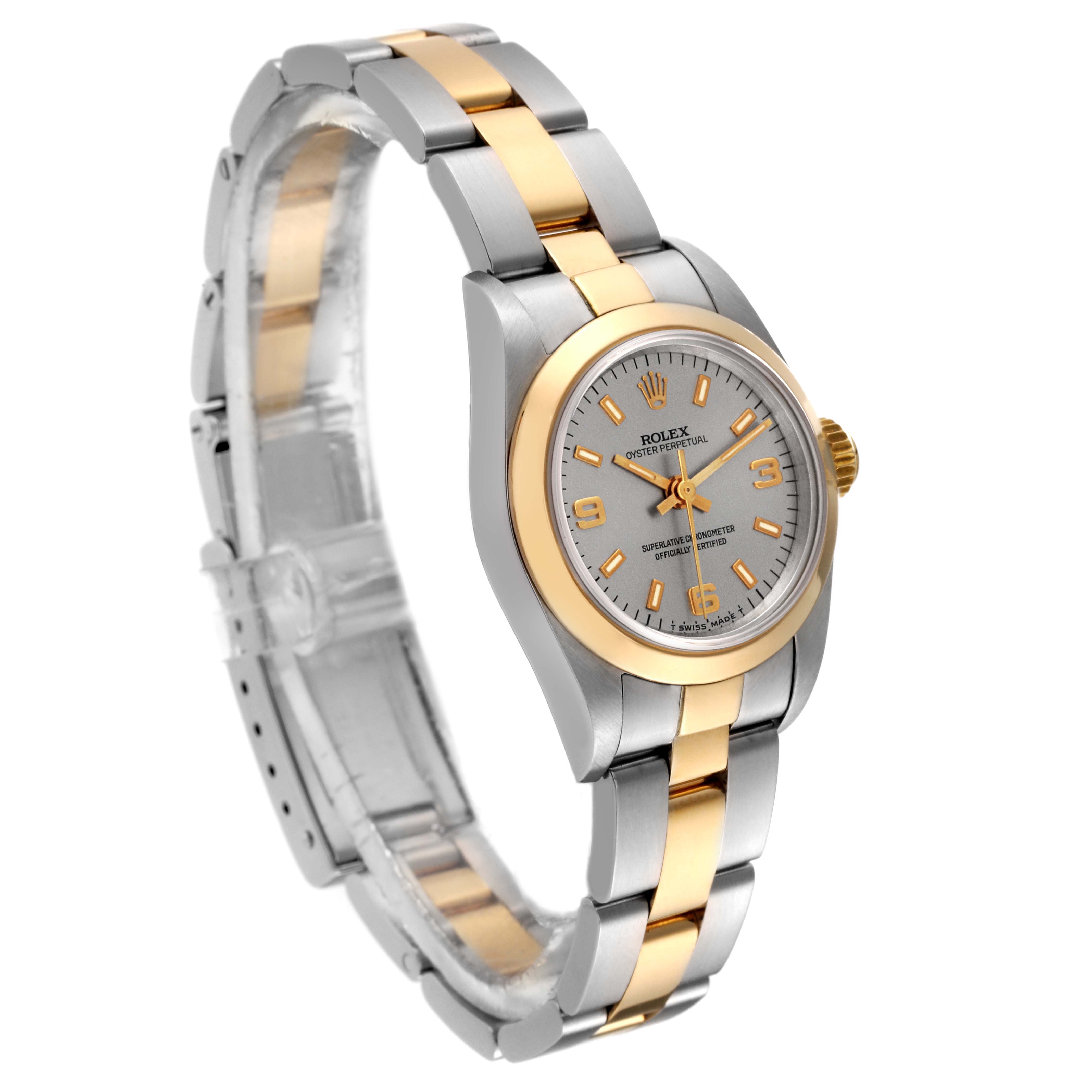 The Rolex Oyster Perpetual 67183 Women's Steel and Gold (two tone) Silver Dial 67183 Women's Steel and Gold (two tone) Silver Dial watch is shown at an angled view, highlighting the dial, bezel, and bracelet.