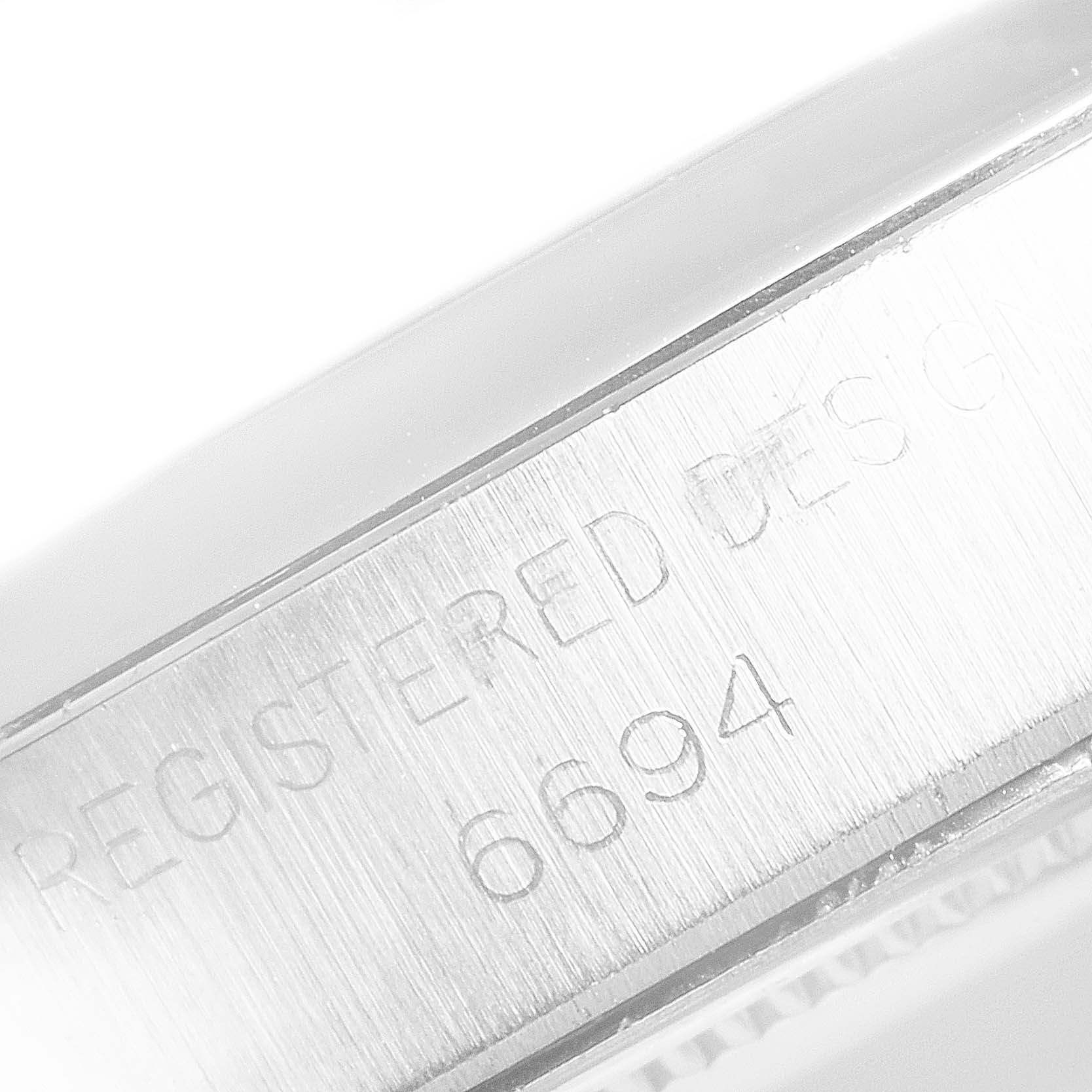 The image shows the side of a Vintage Collection Rolex watch, focusing on its engraved case number "6694."